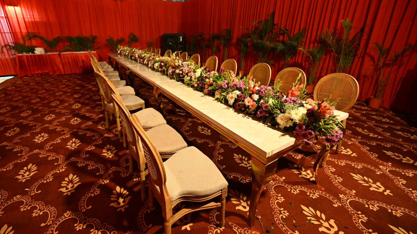Long dining table with floral arrangements