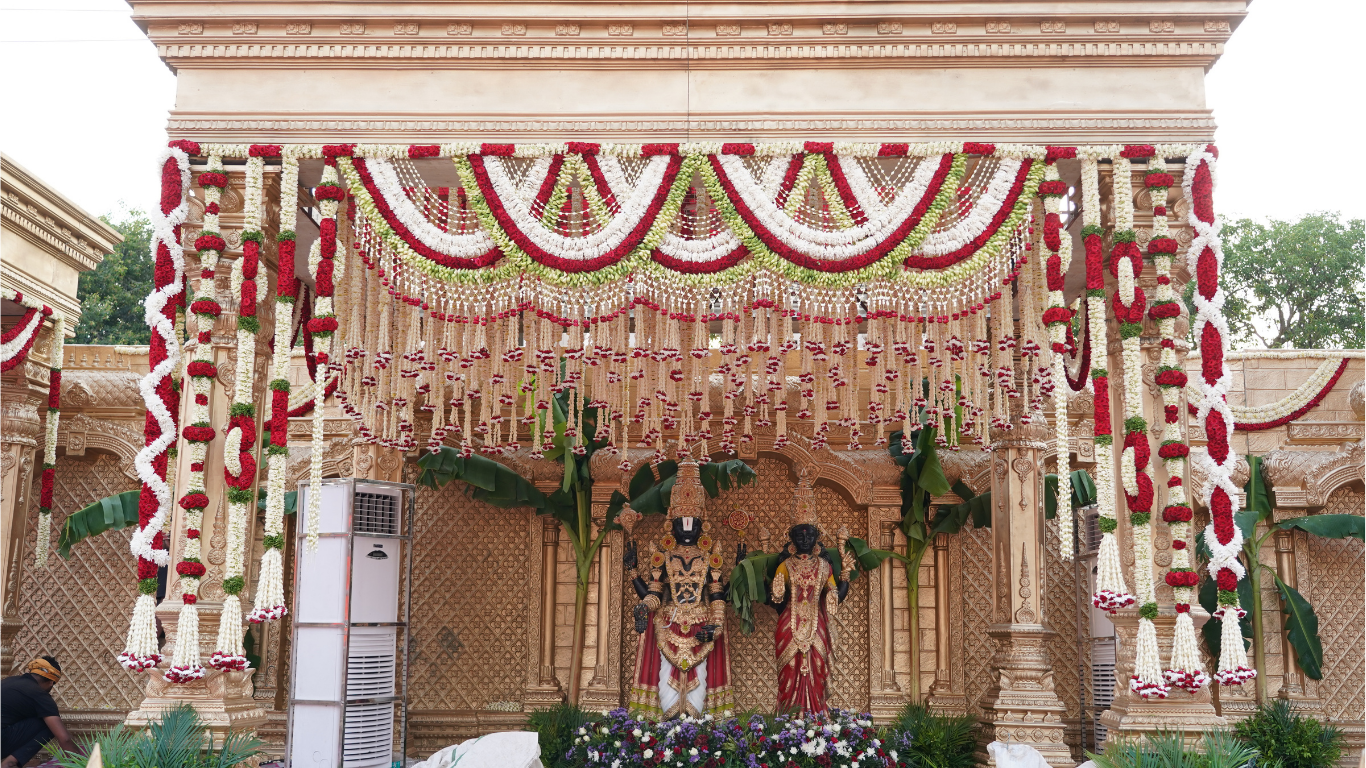 Temple wedding mandap with red and white floral decor