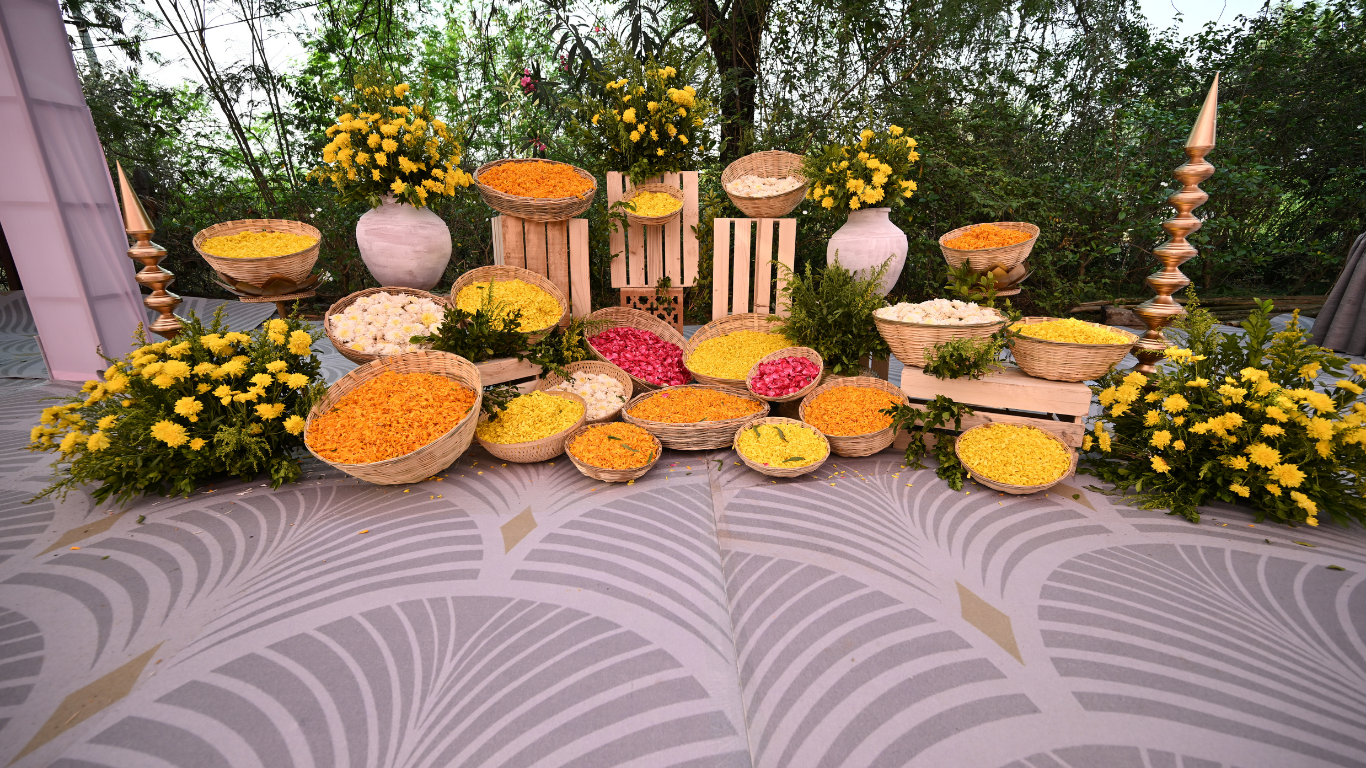 Haldi flower display with marigolds, rose petals and yellow blooms in wicker baskets
