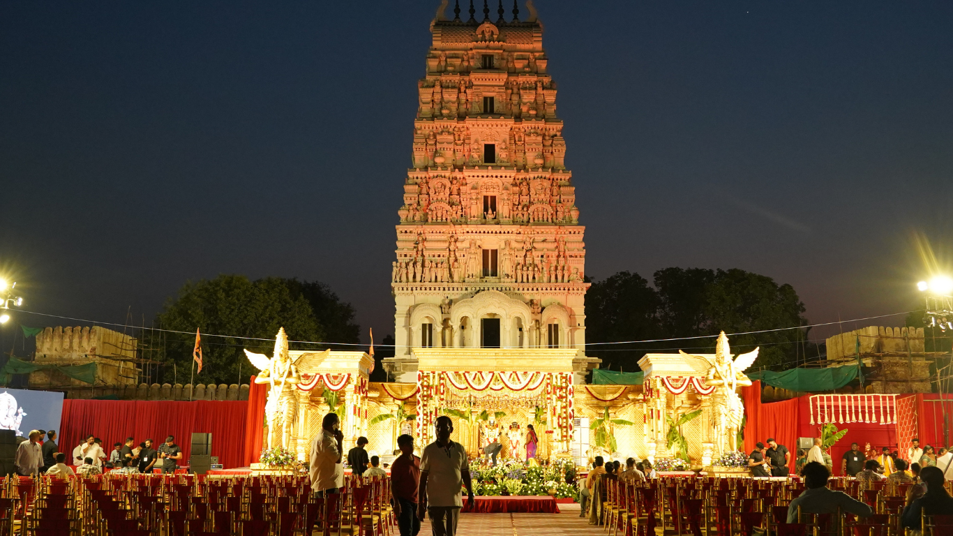 Wide night view of the Ammapalli temple wedding venue with guest seating