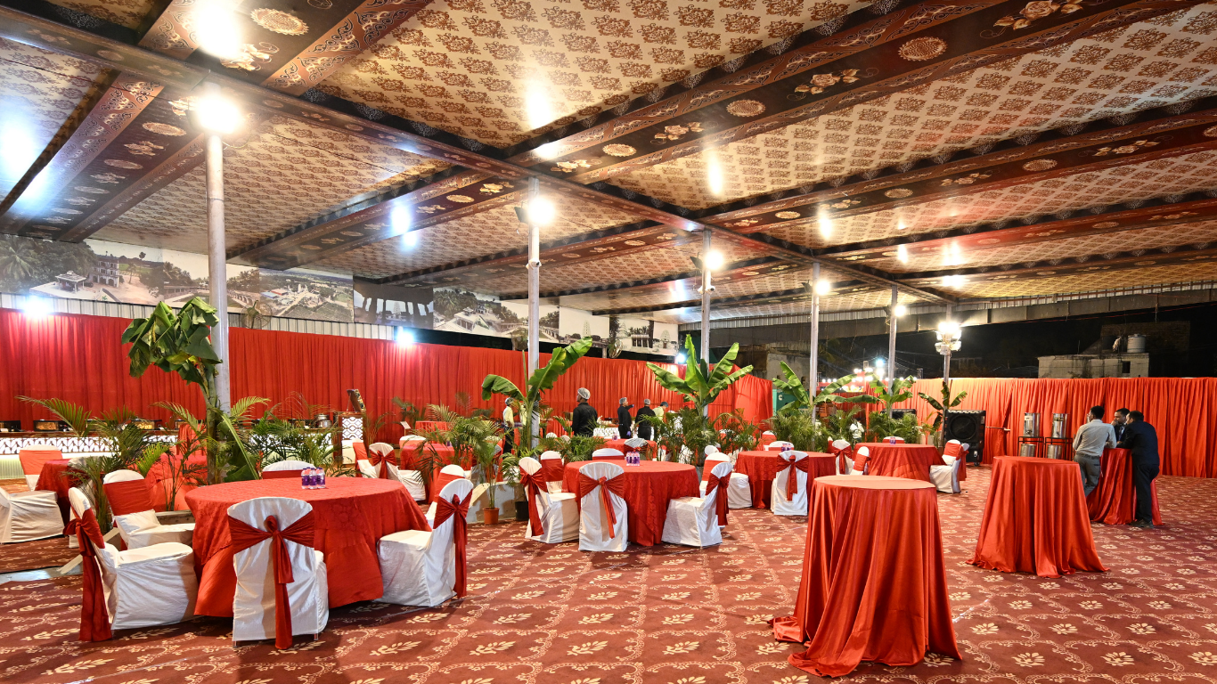 Wedding seating area with round tables and red decor